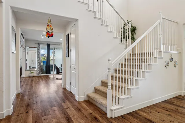a view of entryway and hall with wooden floor