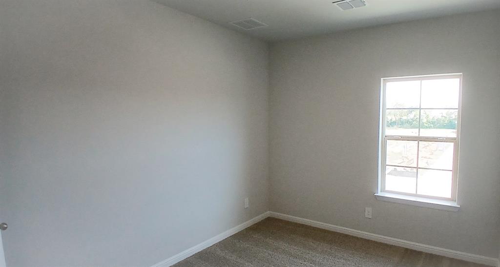 525 Pendleton Avenue Keene, TX 76059 - Photo 10 of 15 an empty room with a window