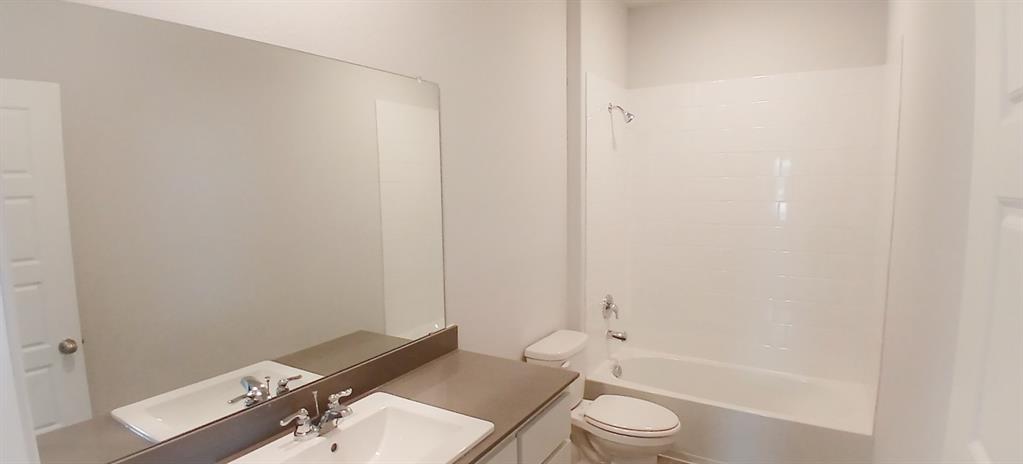 525 Pendleton Avenue Keene, TX 76059 - Photo 8 of 15 a bathroom with a sink a toilet and a bathtub