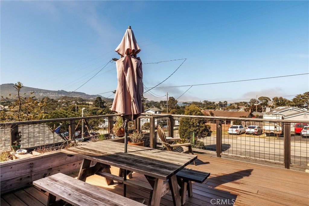 1228 7th Street Los Osos, CA 93402 - Photo 12 of 44 a view of a balcony with chairs and wooden floor