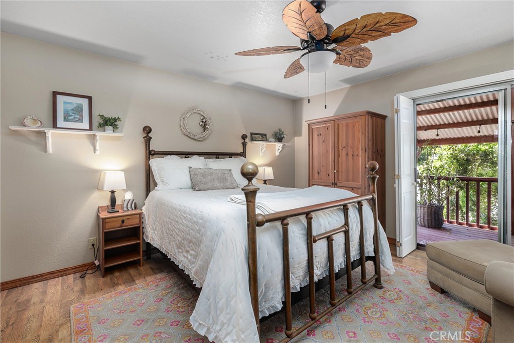 1228 7th Street Los Osos, CA 93402 - Photo 16 of 44 a bedroom with a bed and a chandelier