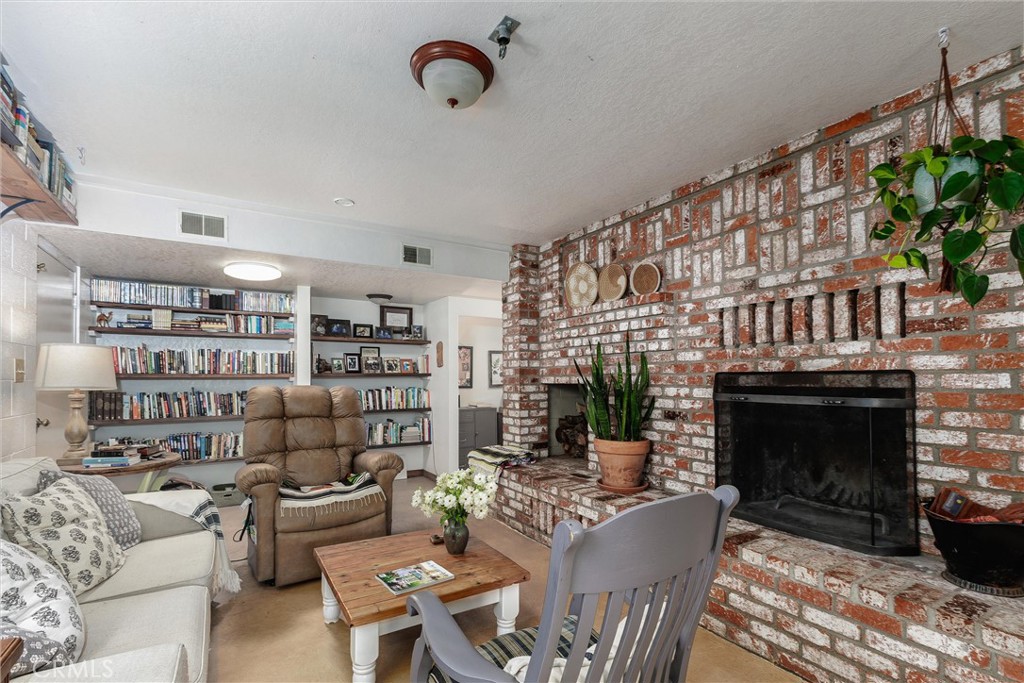 1228 7th Street Los Osos, CA 93402 - Photo 19 of 44 a living room with furniture a rug and a fireplace
