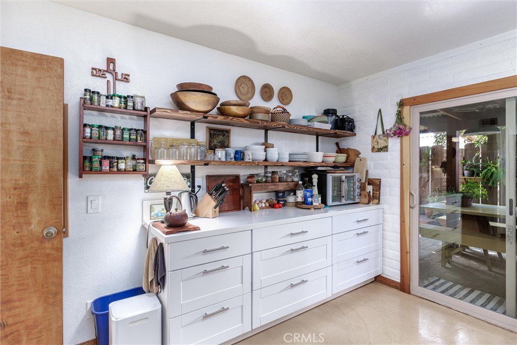1228 7th Street Los Osos, CA 93402 - Photo 21 of 44 a kitchen with stainless steel appliances granite countertop a sink and cabinets