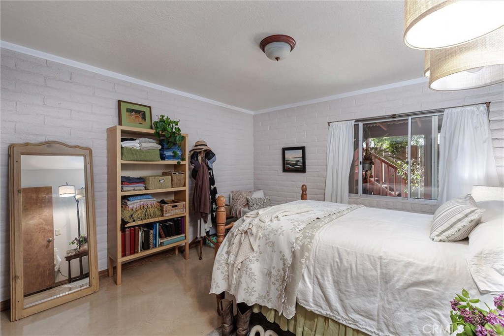 1228 7th Street Los Osos, CA 93402 - Photo 23 of 44 a bedroom with a bed and a book shelf