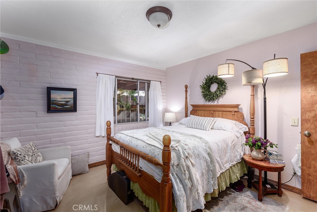 1228 7th Street Los Osos, CA 93402 - Photo 24 of 44 a bedroom with a bed and a table