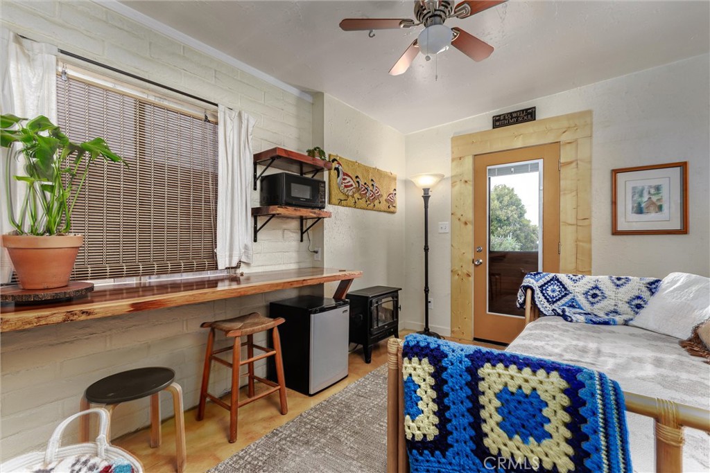 1228 7th Street Los Osos, CA 93402 - Photo 26 of 44 a bedroom with furniture and a potted plant