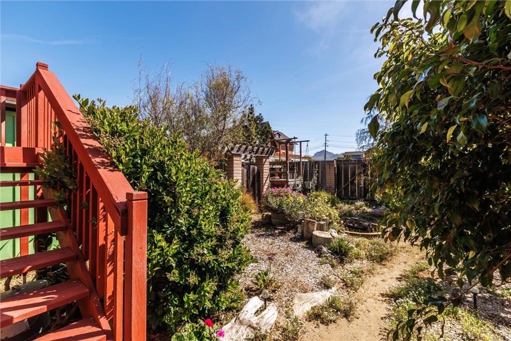 1228 7th Street Los Osos, CA 93402 - Photo 34 of 44 a backyard of a house with lots of green space