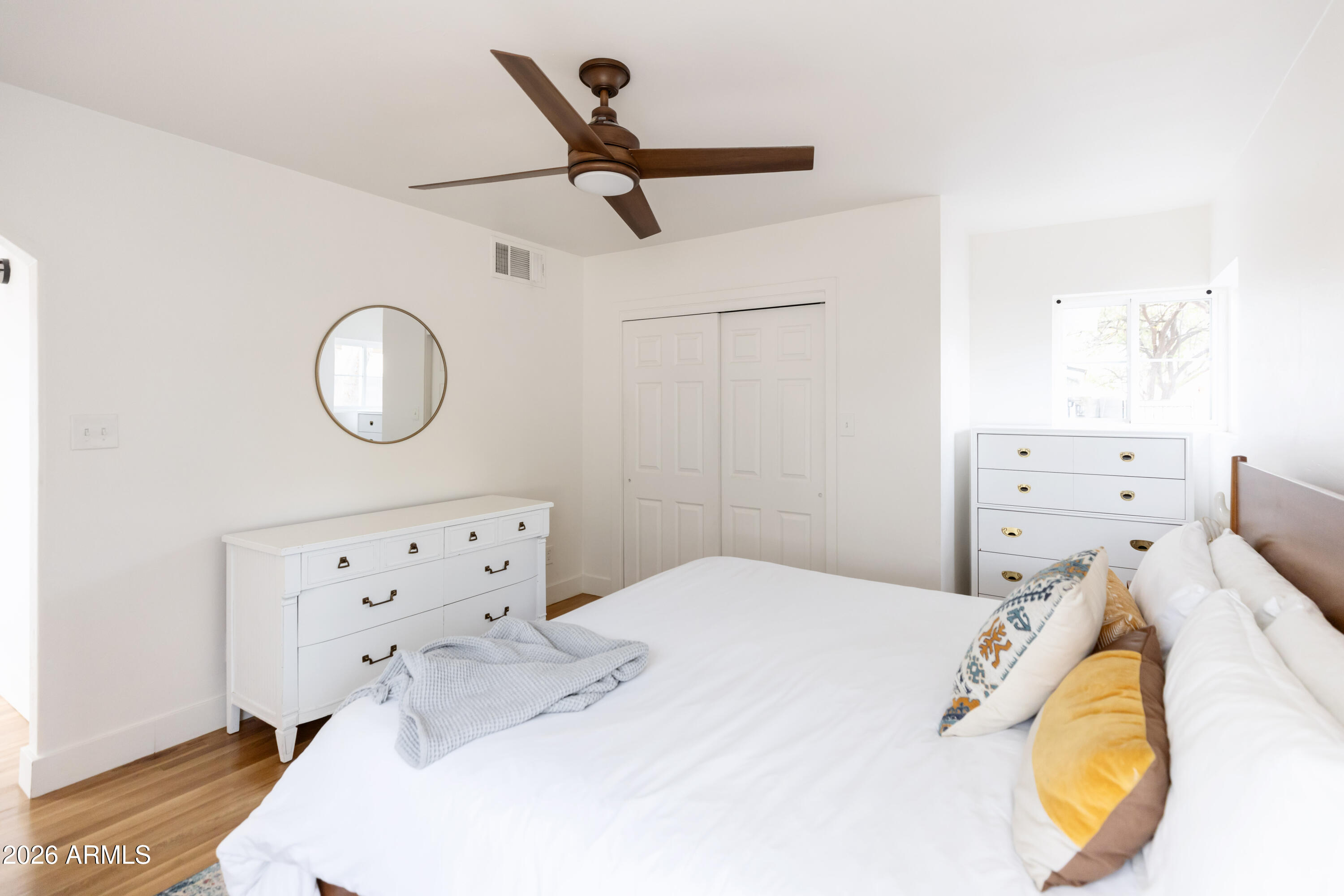 3715 North 9th Place Phoenix, AZ 85014 - Photo 33 of 41 a bedroom with a bed and wooden floor