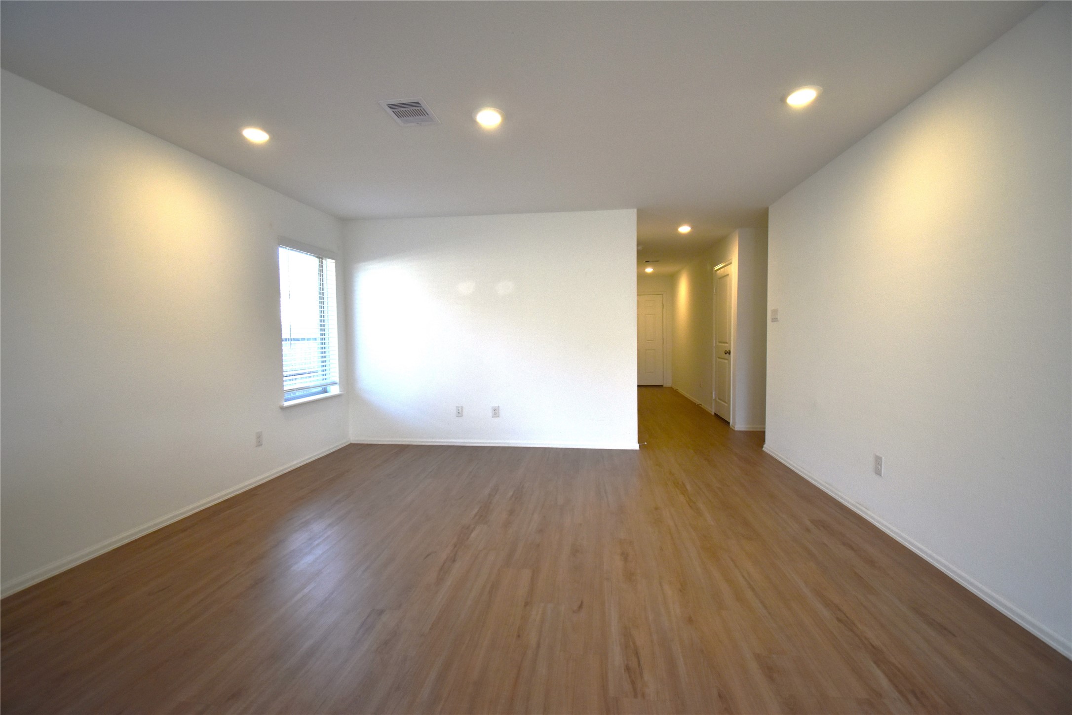 3326 Spanish Oak Lane Rosenberg, TX 77471 - Photo 20 of 24 an empty room with wooden floor and windows