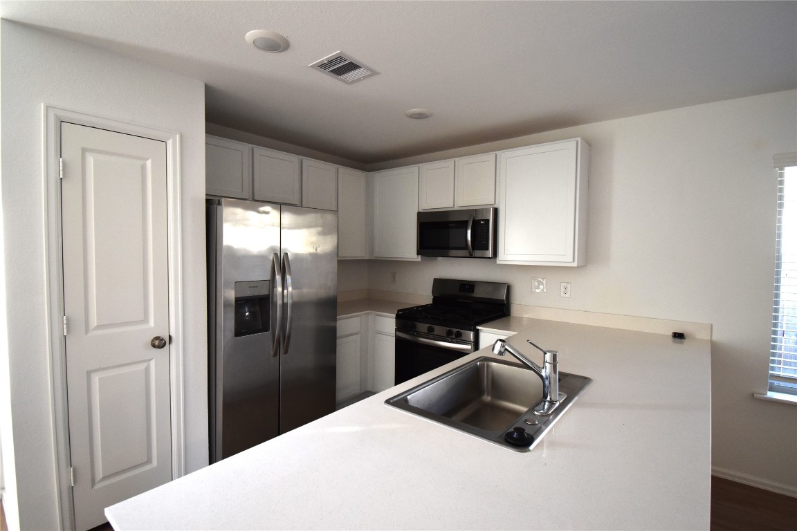 3326 Spanish Oak Lane Rosenberg, TX 77471 - Photo 6 of 24 a kitchen with a refrigerator sink and microwave