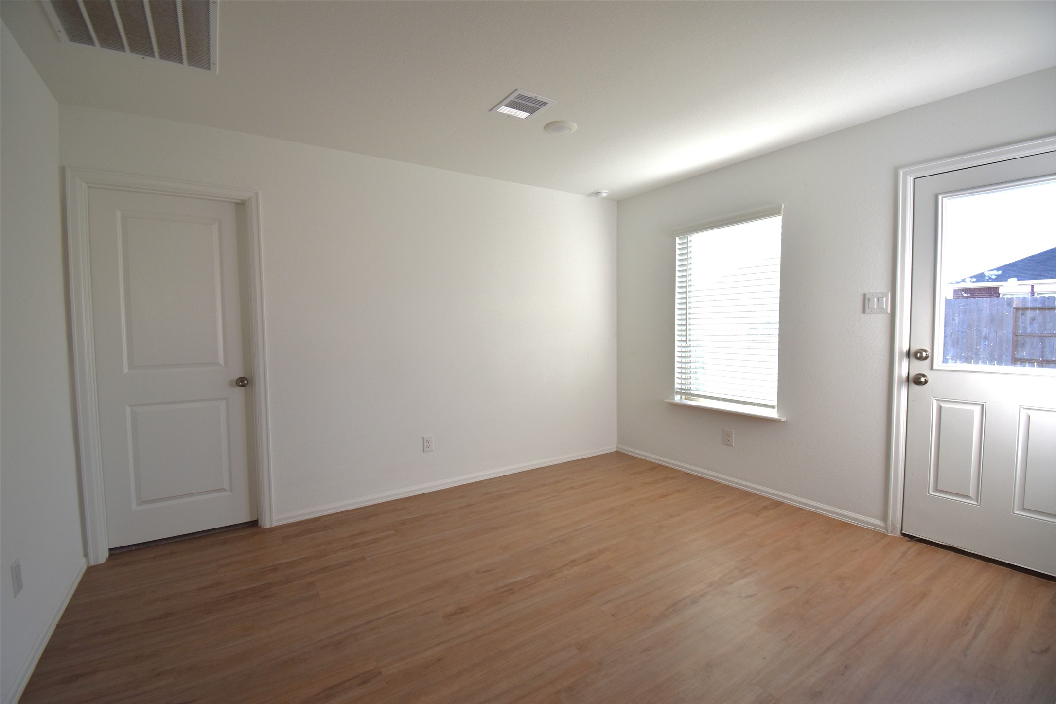 3326 Spanish Oak Lane Rosenberg, TX 77471 - Photo 7 of 24 an empty room with wooden floor and windows