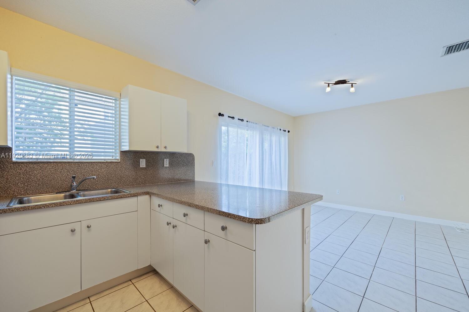 8521 Southwest 214th Terrace Cutler Bay, FL 33189 - Photo 13 of 21 a kitchen with a sink cabinets and utility
