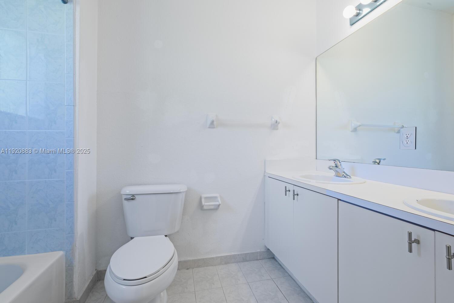 8521 Southwest 214th Terrace Cutler Bay, FL 33189 - Photo 16 of 21 a bathroom with a toilet a sink and mirror