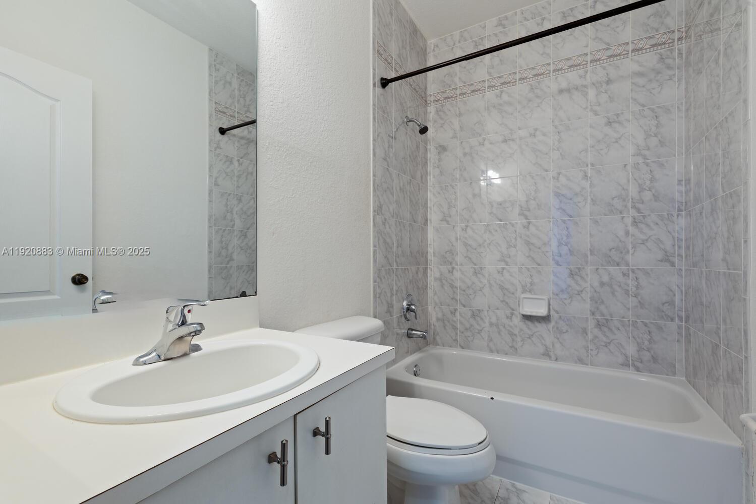 8521 Southwest 214th Terrace Cutler Bay, FL 33189 - Photo 20 of 21 a bathroom with a sink toilet and shower