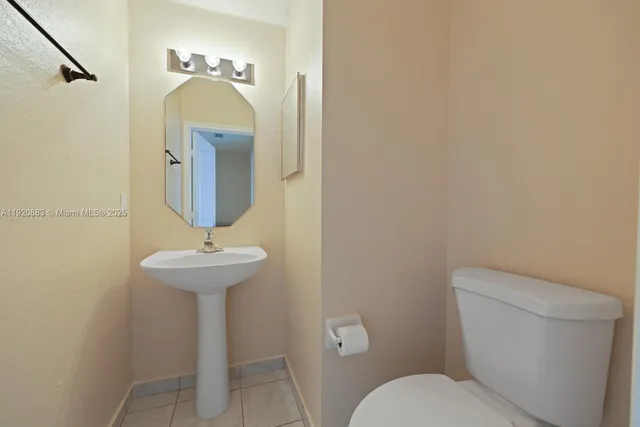 a view of kitchen with stainless steel appliances granite countertop a sink refrigerator and microwave