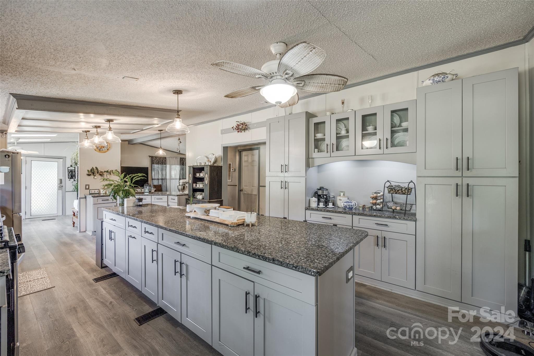 1574 Dunlap Roddey Road Rock Hill, SC 29730 - Photo 12 of 35 a kitchen with kitchen island granite countertop a sink and refrigerator