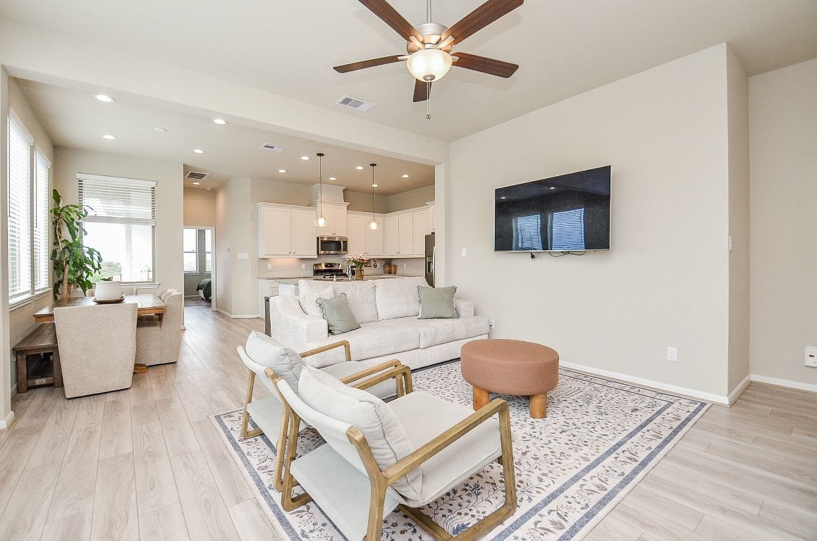 a living room with furniture a flat screen tv and a rug