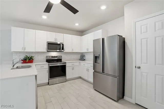 a kitchen with cabinets stainless steel appliances and a counter space