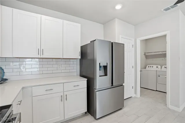 a white refrigerator freezer sitting in a kitchen