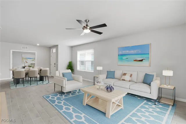 a living room with furniture a rug and a window