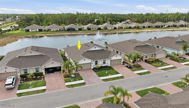an aerial view of a house with outdoor space and lake view