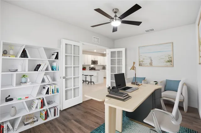 a view of a workspace with furniture and wooden floor