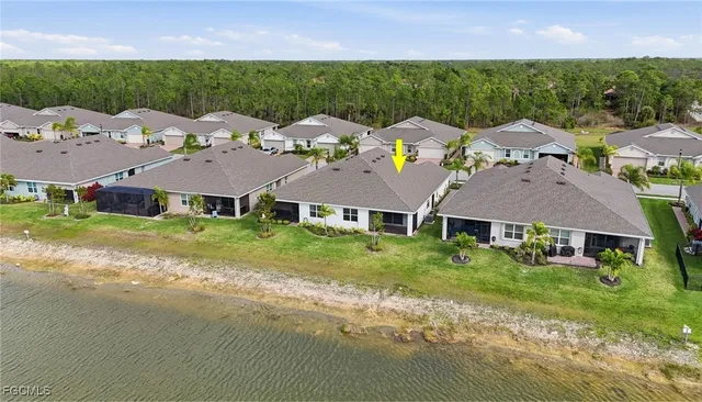 aerial view of a house with yard and green space