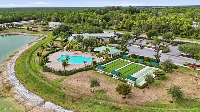 an aerial view of a house with a garden and lake view