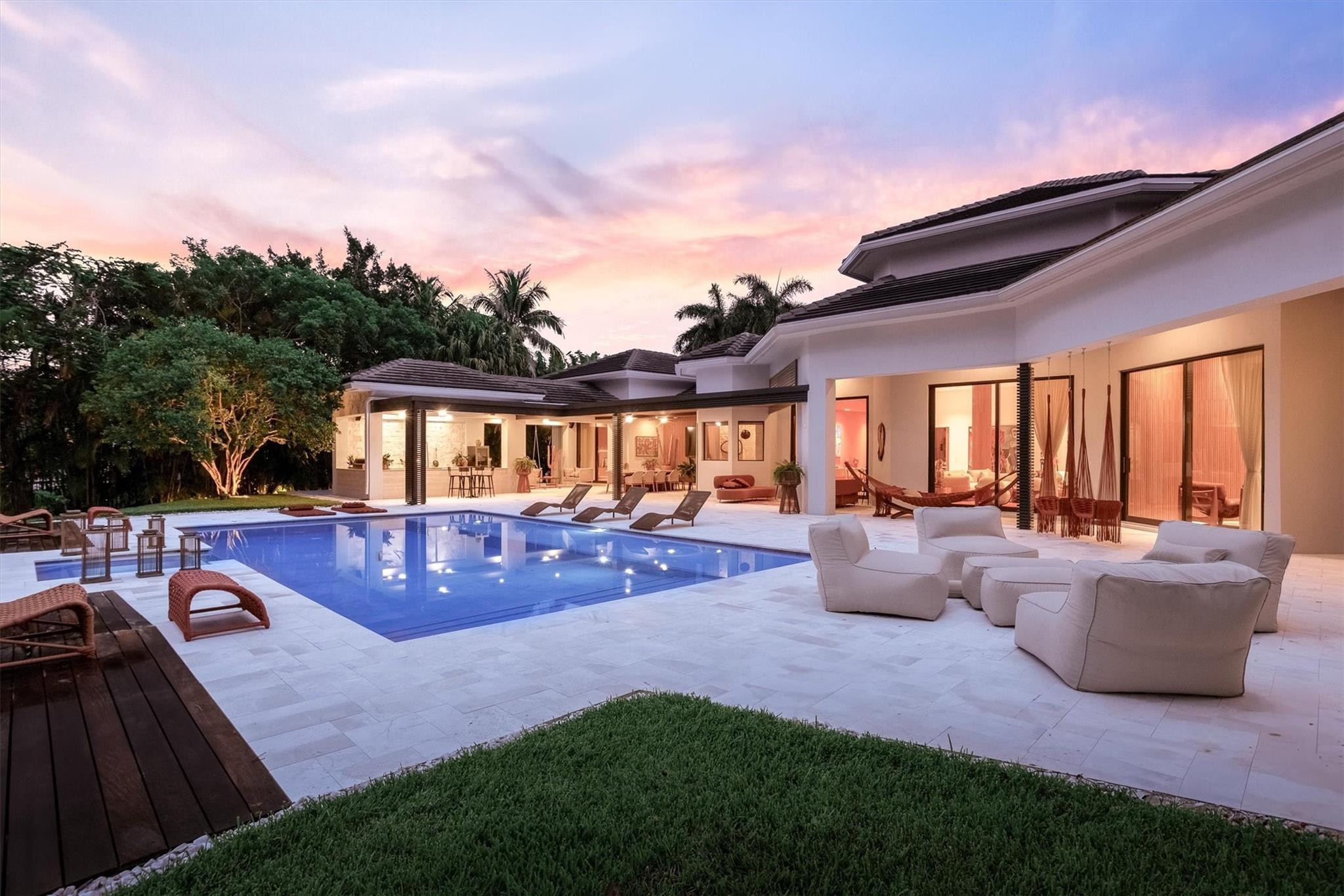 3340 Paddock Road Weston, FL 33331 - Photo 24 of 68 a view of a patio with couches chairs and a fire pit
