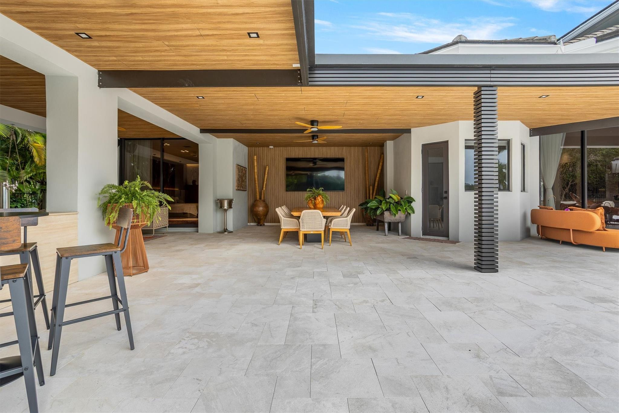 3340 Paddock Road Weston, FL 33331 - Photo 29 of 68 a view of a patio with table and chairs potted plants and floor to ceiling window