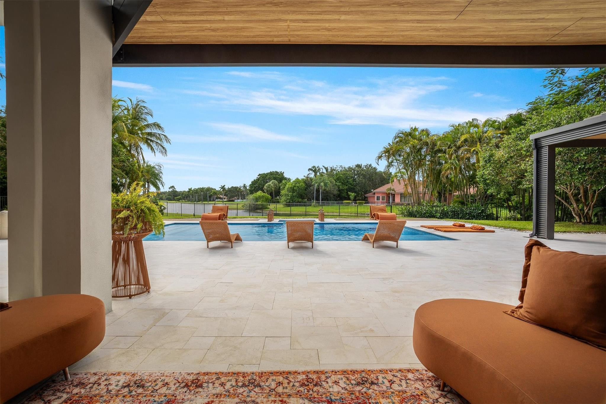 3340 Paddock Road Weston, FL 33331 - Photo 32 of 68 a view of swimming pool with lounge chair and dinning table under an umbrella