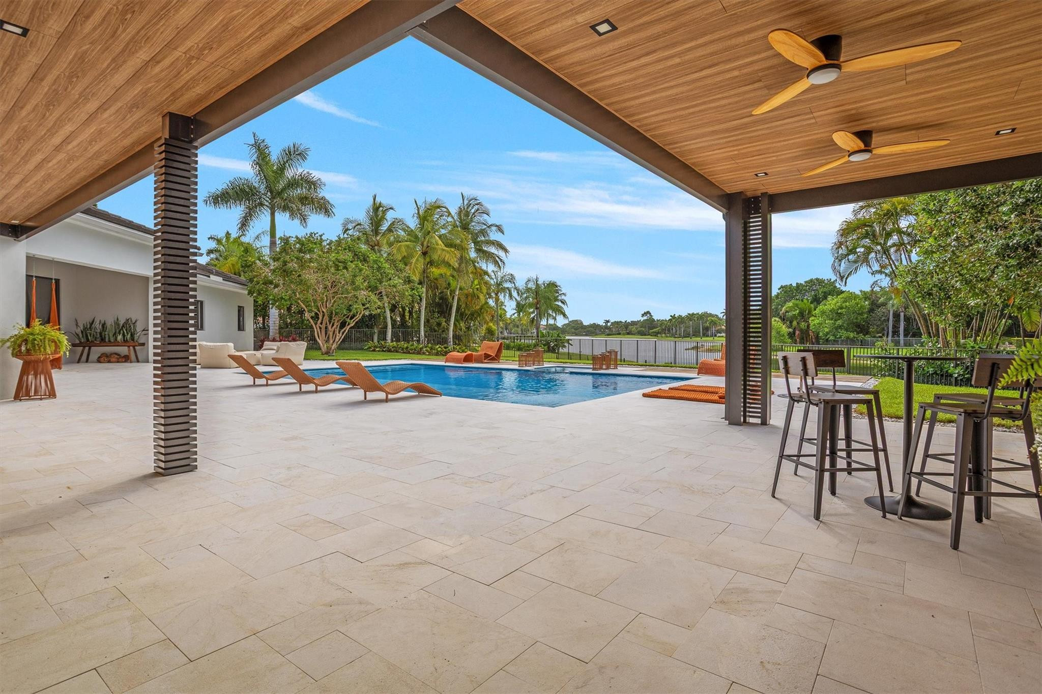 3340 Paddock Road Weston, FL 33331 - Photo 33 of 68 a view of swimming pool with lawn chairs and floor to ceiling window