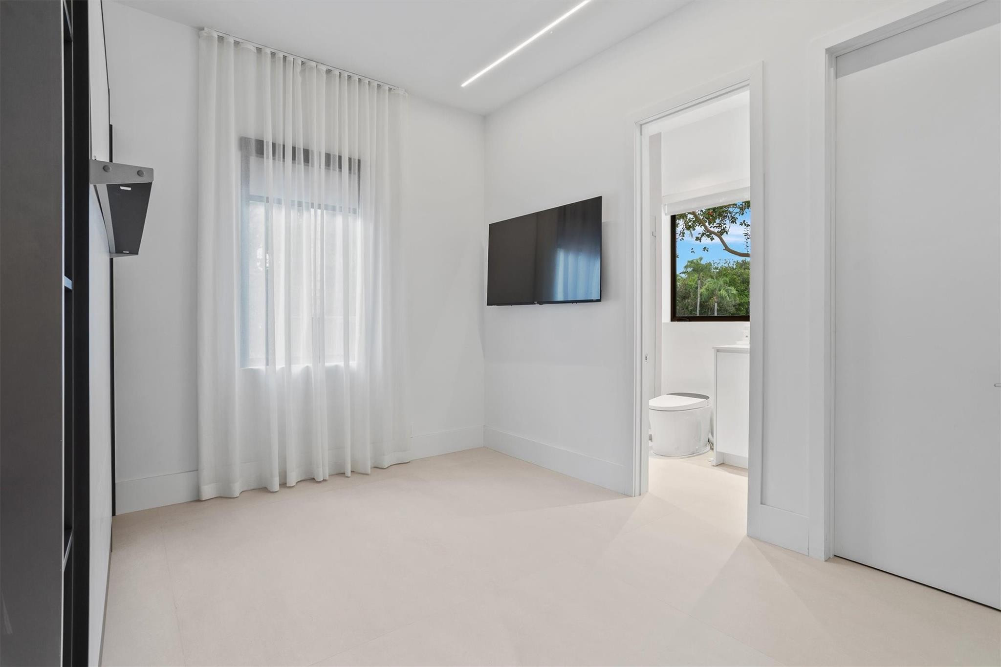 3340 Paddock Road Weston, FL 33331 - Photo 58 of 68 a view of a livingroom with an empty space and a flat screen tv