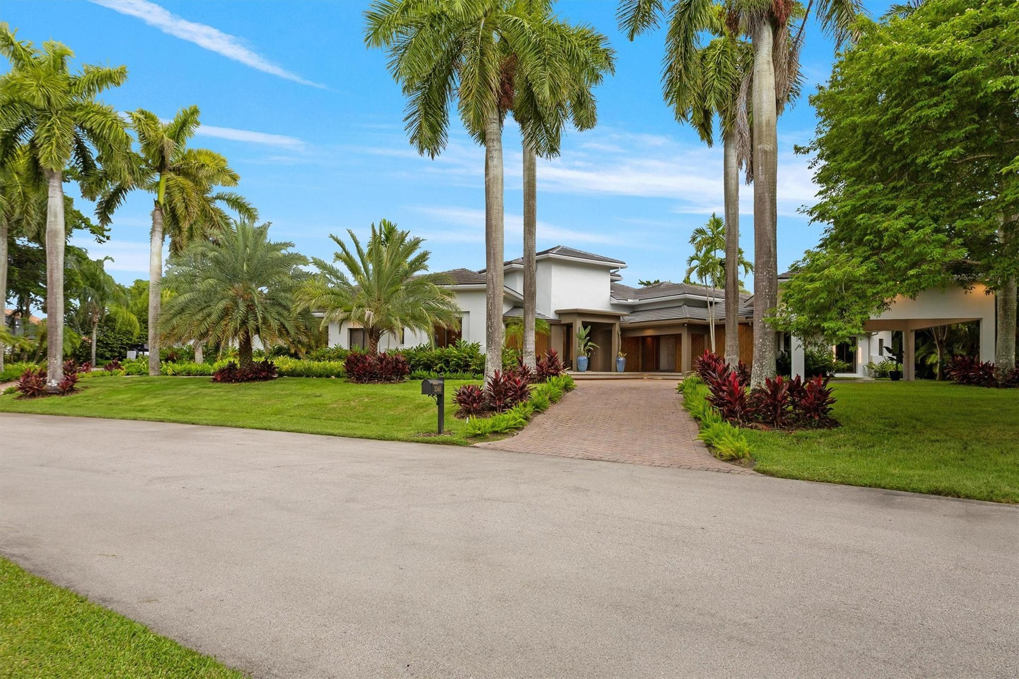 3340 Paddock Road Weston, FL 33331 - Photo 65 of 68 a front view of house with yard and green space