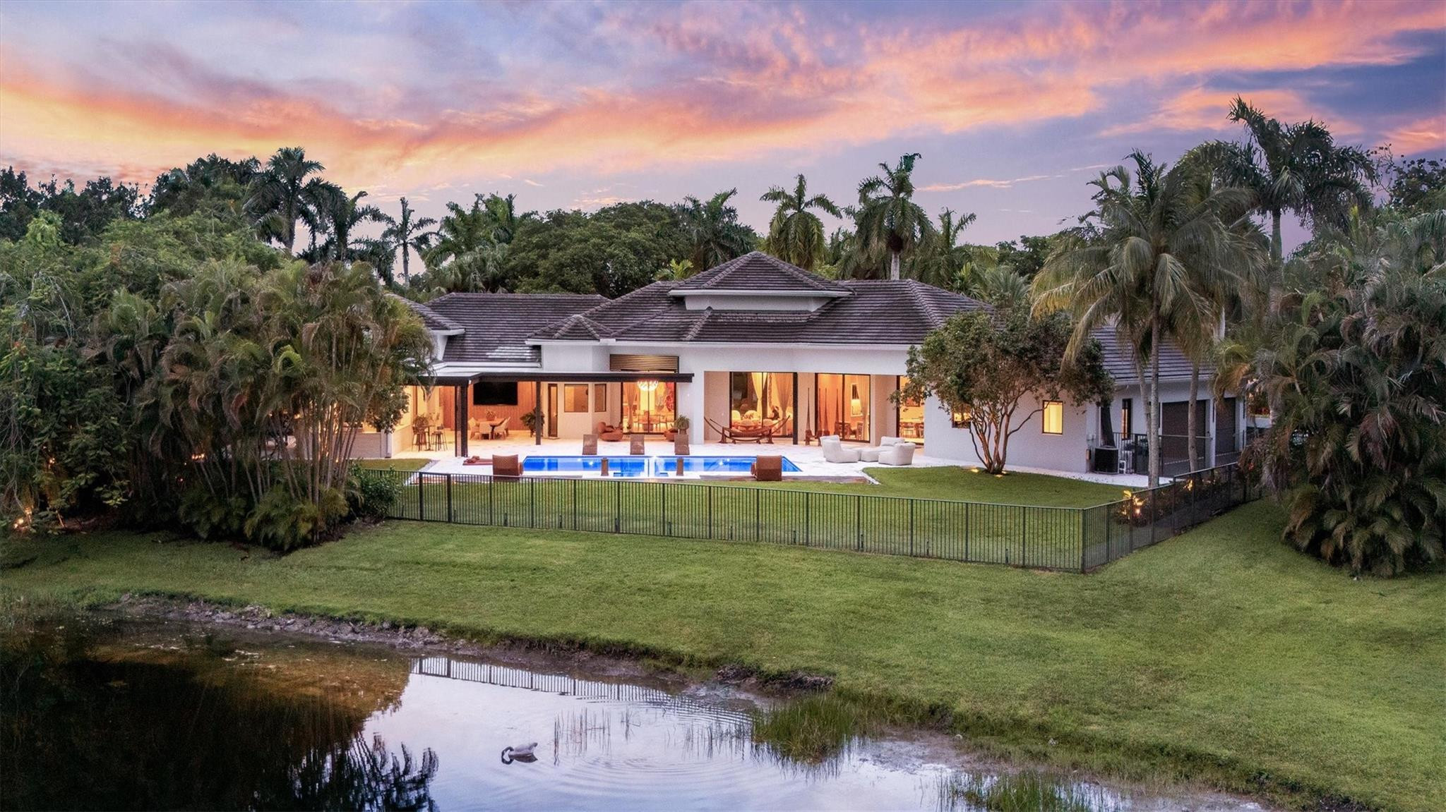 3340 Paddock Road Weston, FL 33331 - Photo 66 of 68 a view of a white house with a big yard and a large tree