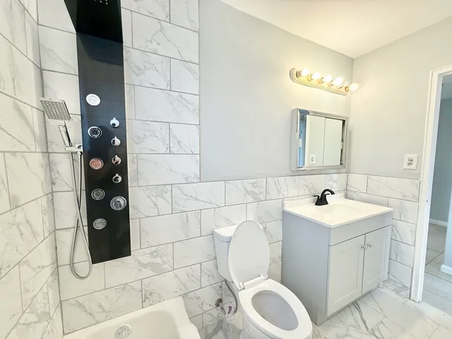 a bathroom with a sink toilet and shower