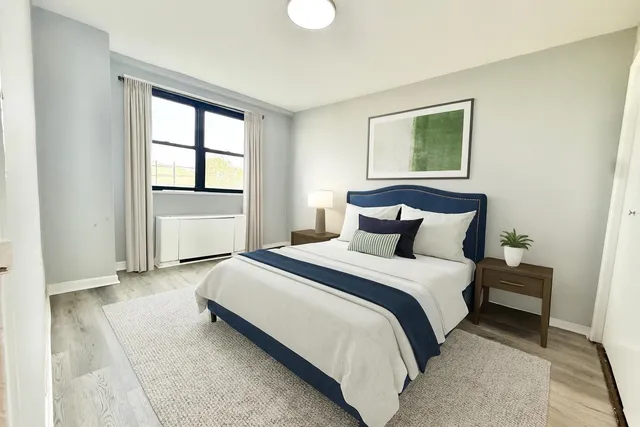 a bedroom with a bed and a window