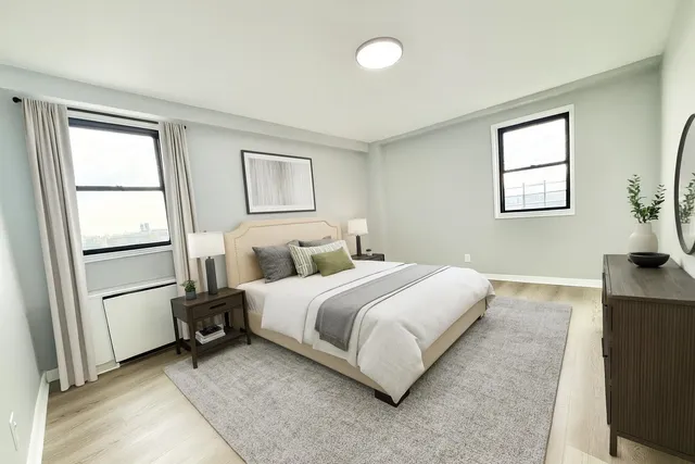 a spacious bedroom with a bed and a window