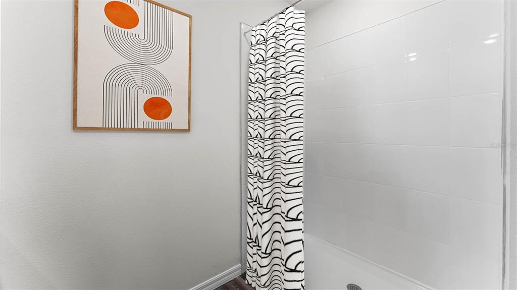 2834 House Finch Road St. Cloud, FL 34773 - Photo 11 of 48 a bathroom with a shower and mirror