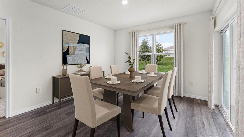 2834 House Finch Road St. Cloud, FL 34773 - Photo 3 of 48 a view of a dining room with furniture window and wooden floor