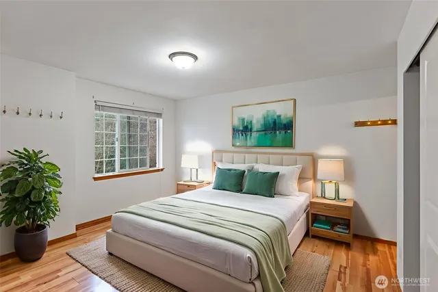 a bedroom with a bed and a potted plant