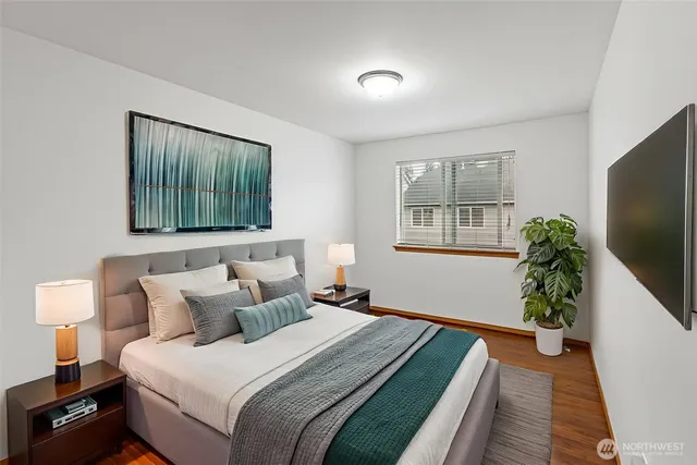 a bedroom with bed and a potted plant