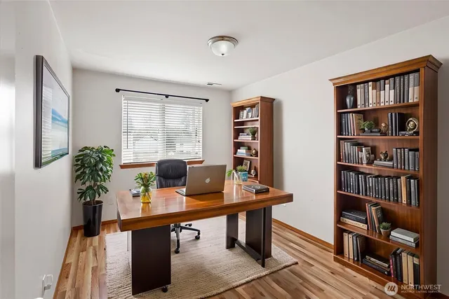 a workspace with furniture and a bookshelf