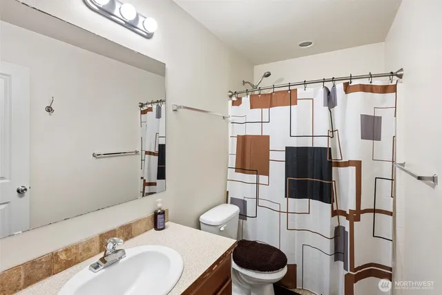 a bathroom with a sink toilet and shower