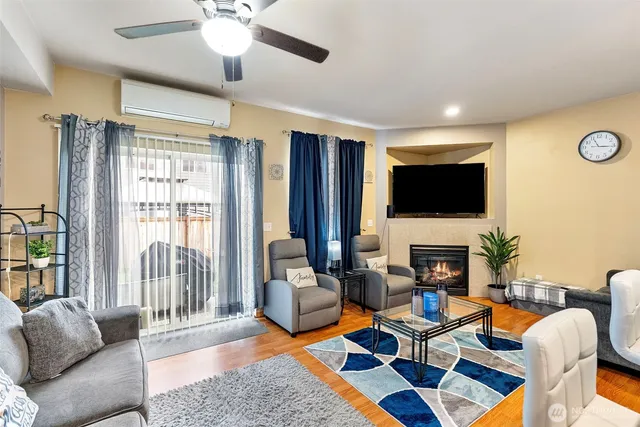 a living room with furniture a fireplace and a flat screen tv