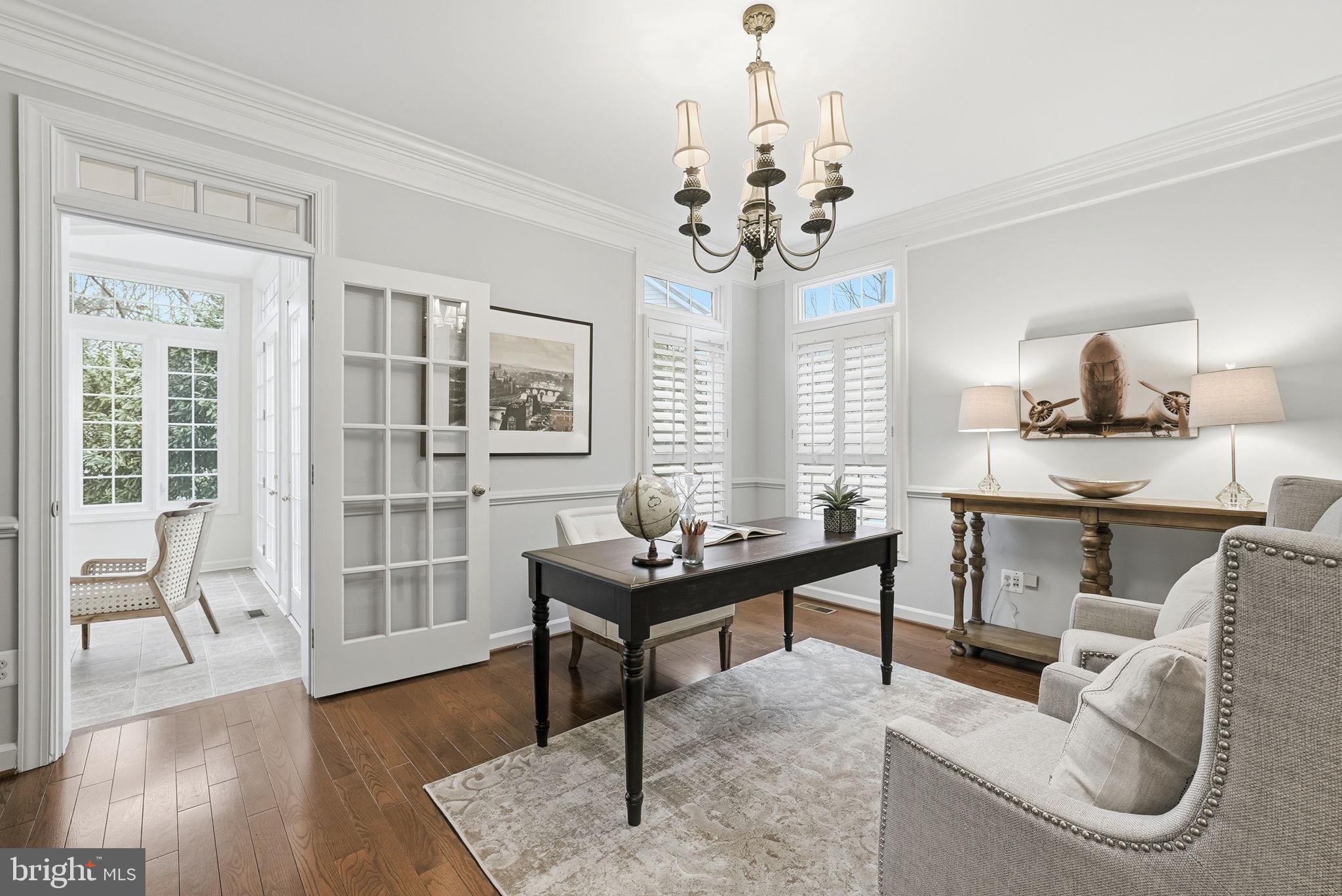 11588 Cedar Chase Road Herndon, VA 20170 - Photo 17 of 81 a living room with furniture a dining table and a chandelier