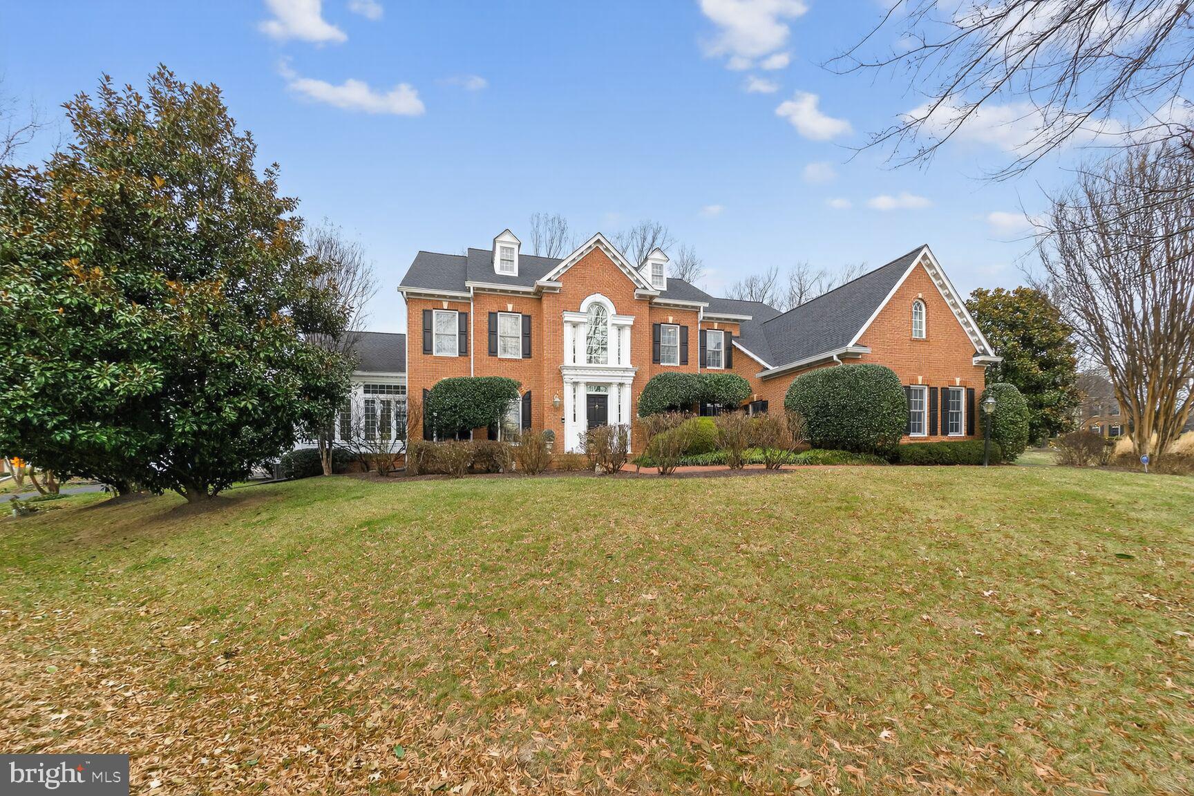 11588 Cedar Chase Road Herndon, VA 20170 - Photo 2 of 81 a front view of house with yard and trees in the background