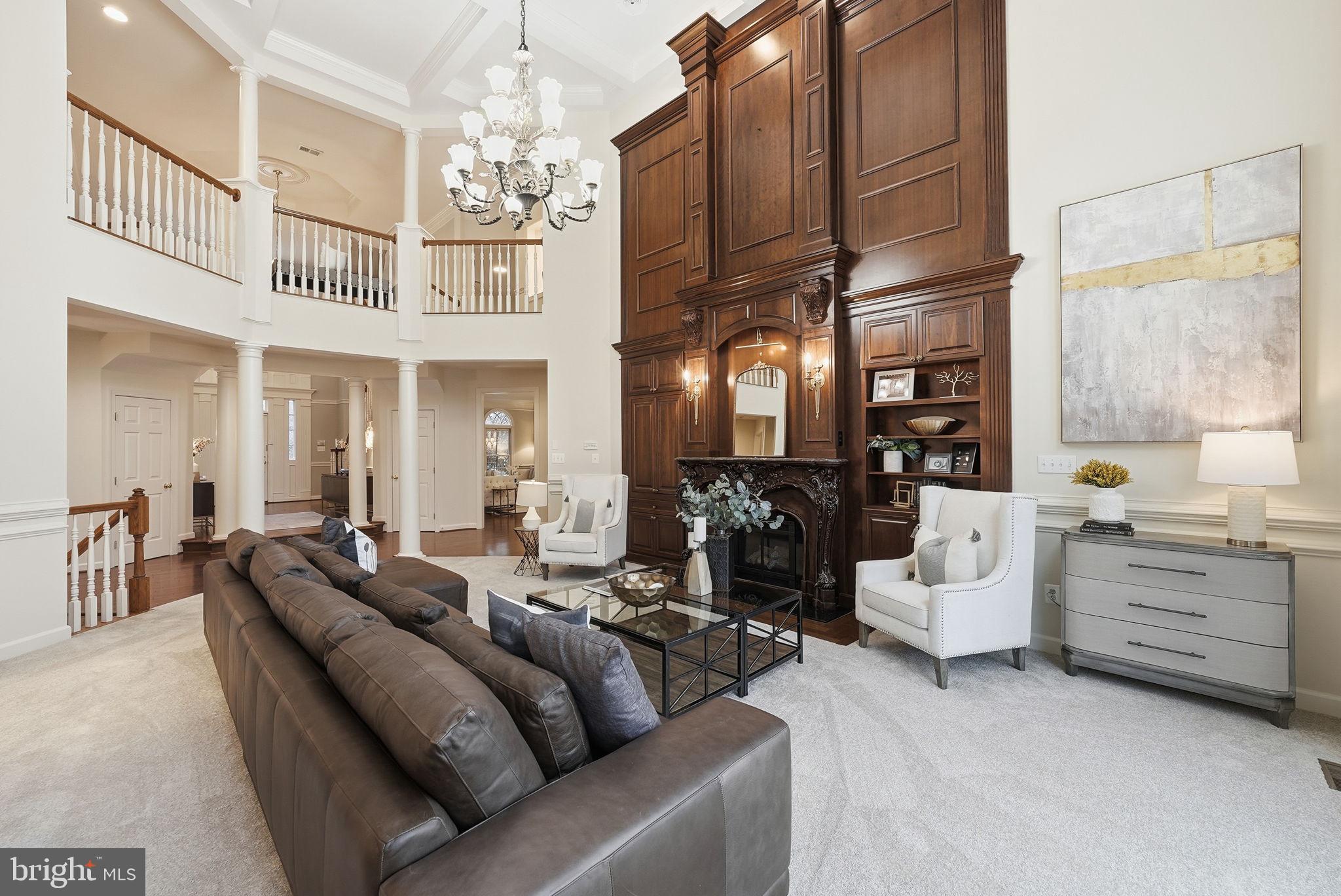 11588 Cedar Chase Road Herndon, VA 20170 - Photo 30 of 81 a living room with furniture a chandelier and a large window