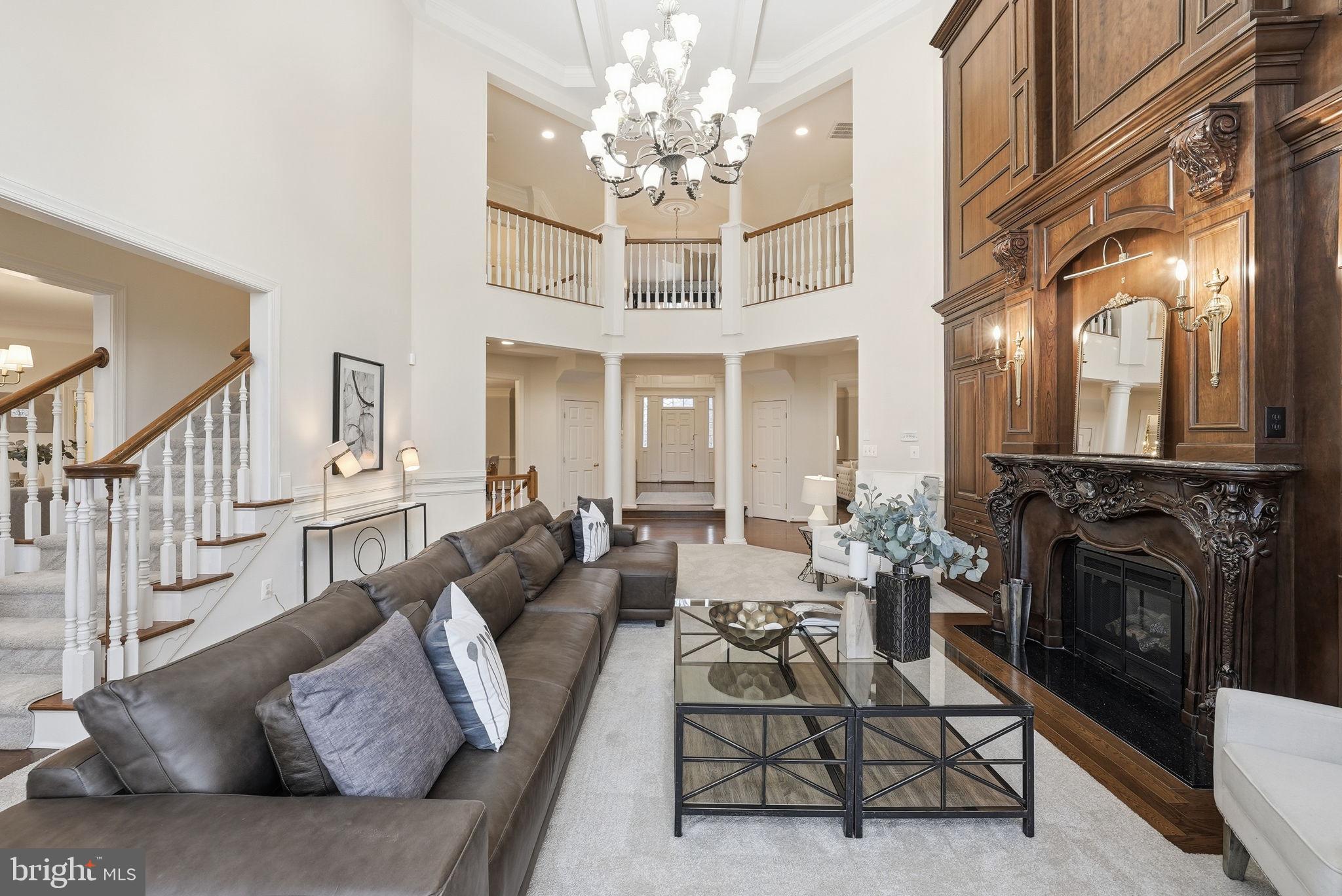 11588 Cedar Chase Road Herndon, VA 20170 - Photo 31 of 81 a living room with furniture a fireplace and a chandelier