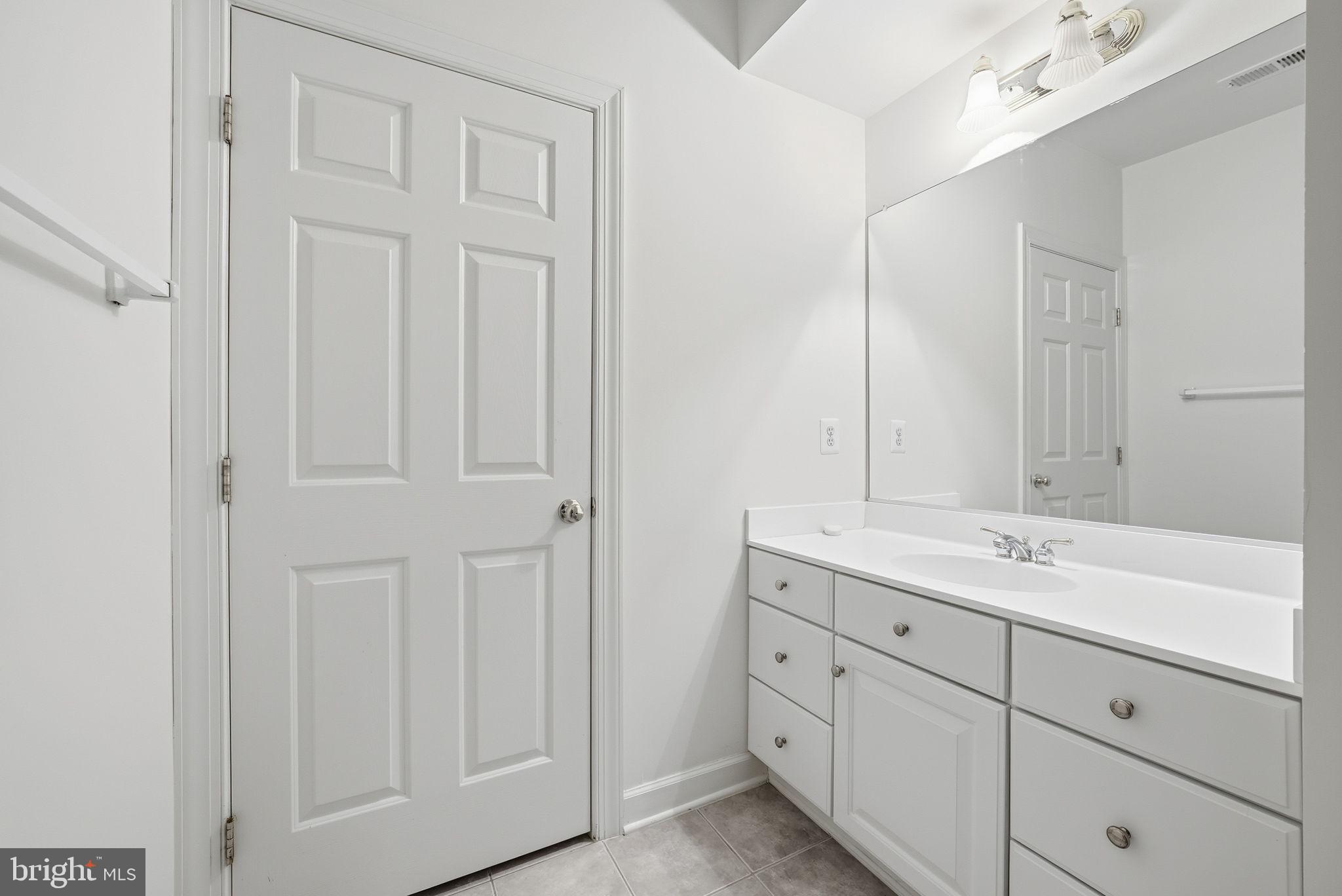 11588 Cedar Chase Road Herndon, VA 20170 - Photo 77 of 81 a en suite bathroom with a granite countertop sink and a mirror